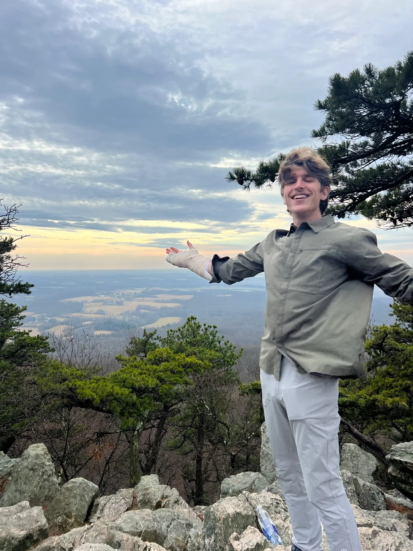 Colton Stephens smiling at a mountain overlook